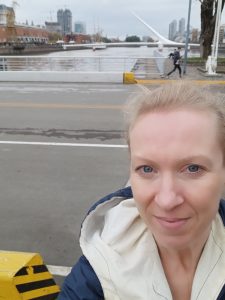 Woman in front of bridge