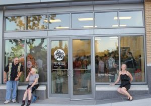 woman in front of crowded art gallery