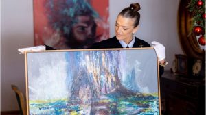 woman holding a painting