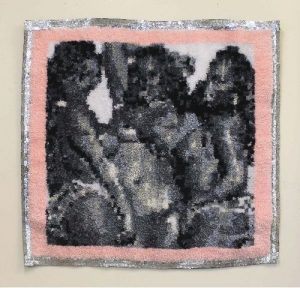 a knit artwork depicting three women