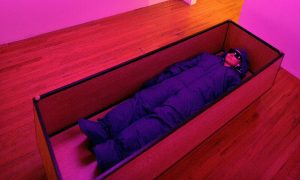 person laying in a wooden bed